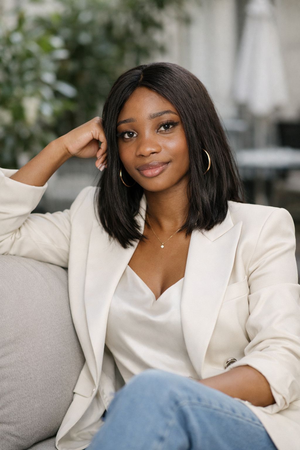 Chioma Iheme, founder of Dear Black Women in Italy, sits relaxed and confident. Her hair is in a shoulder-length bob as she rocks a camisole and a blazer over it.