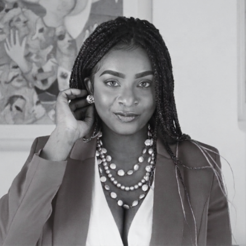 Gloria O. Bethel, UX/UI Designer and Developer, wearing a professional blazer and jewelry in a black and white portrait.